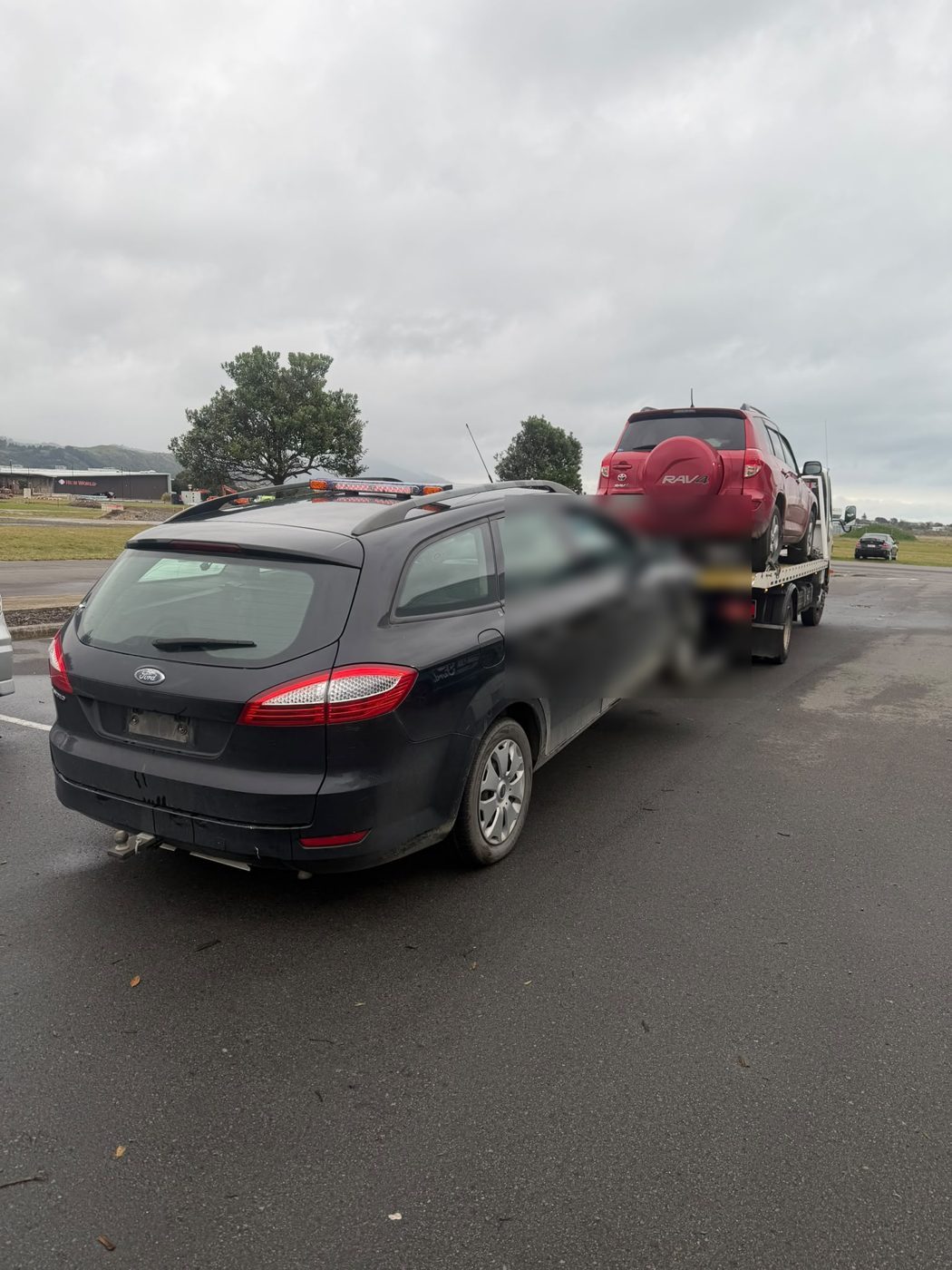 Ford Mondeo wagon and a Toyota RAV4 loaded for removal in Auckland