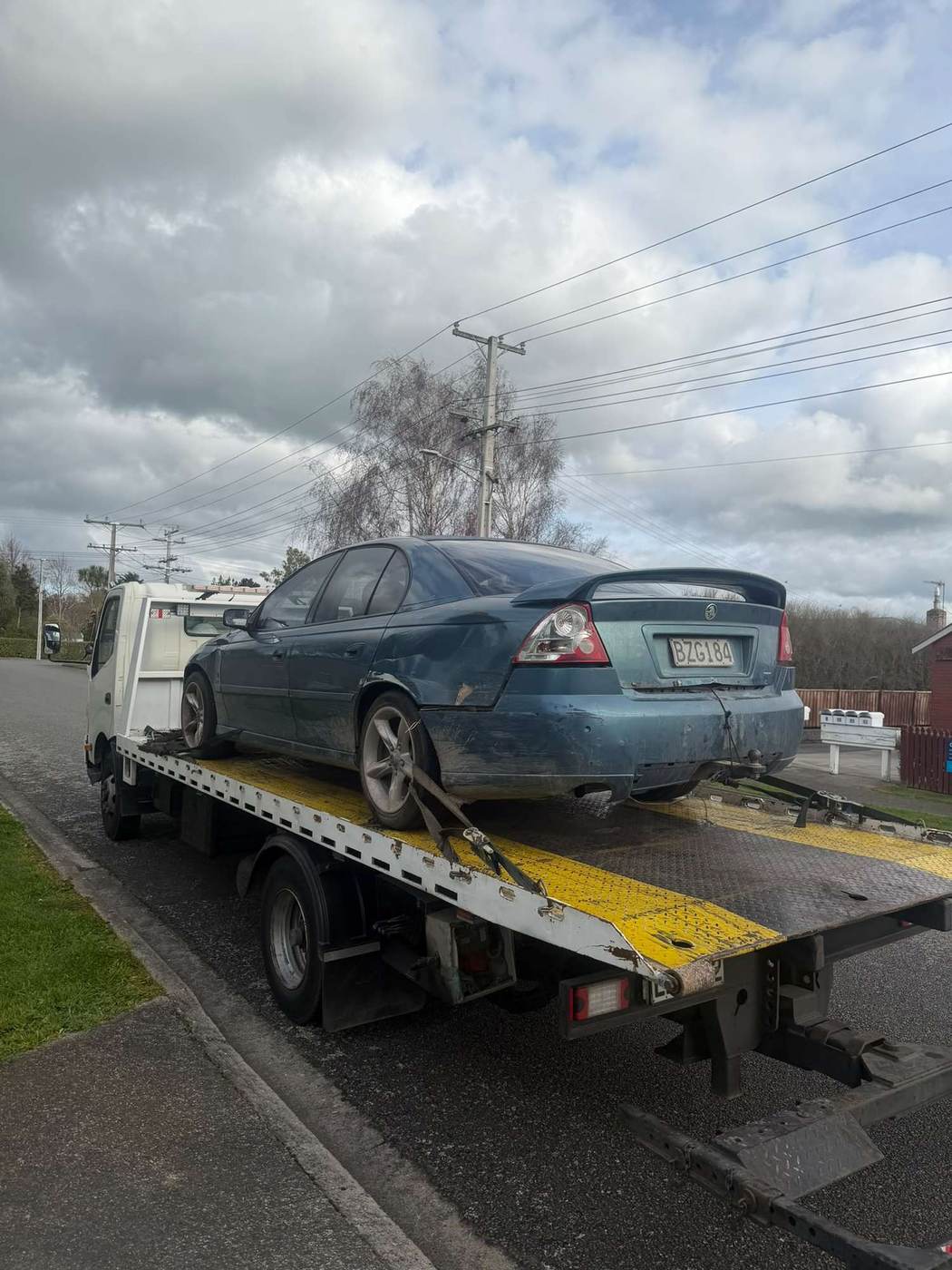 Holden Commodore loaded on a flatbed tow truck in Auckland