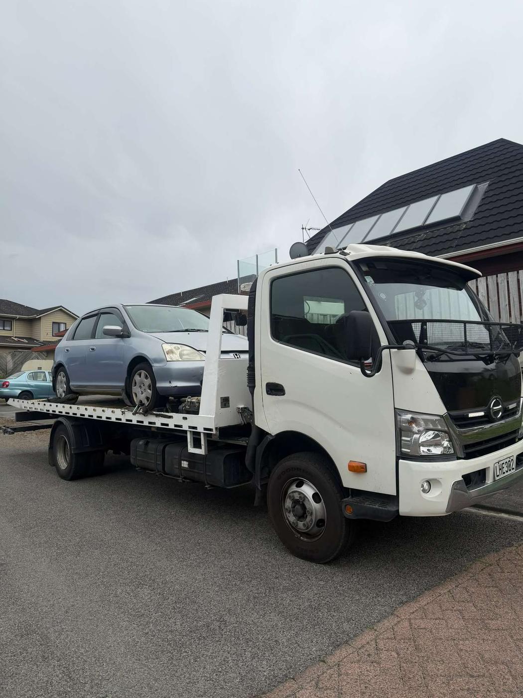 Honda Civic hatchback loaded on a tow truck for free removal in Auckland