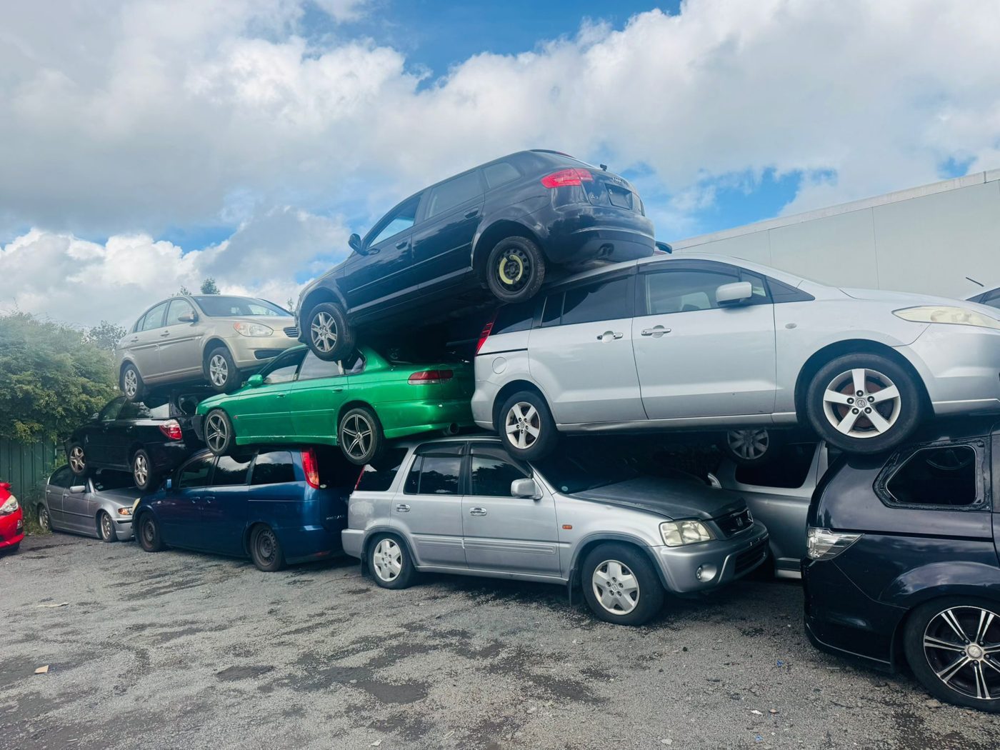 Scrap cars stacked at an Auckland yard after collection