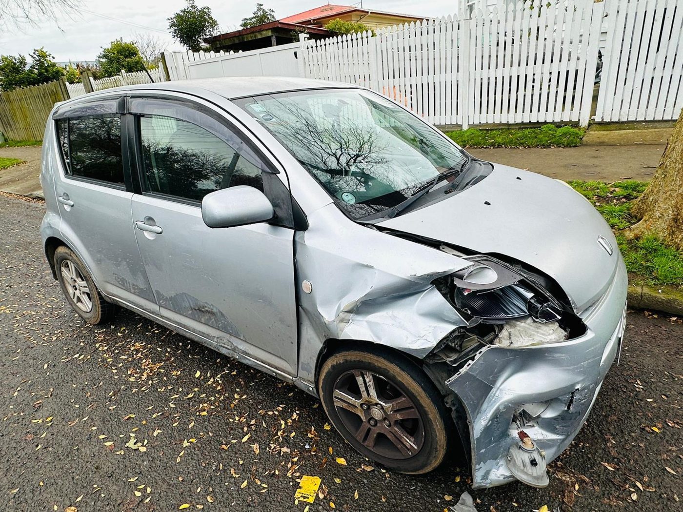 Silver hatchback with heavy front-end crash damage awaiting removal