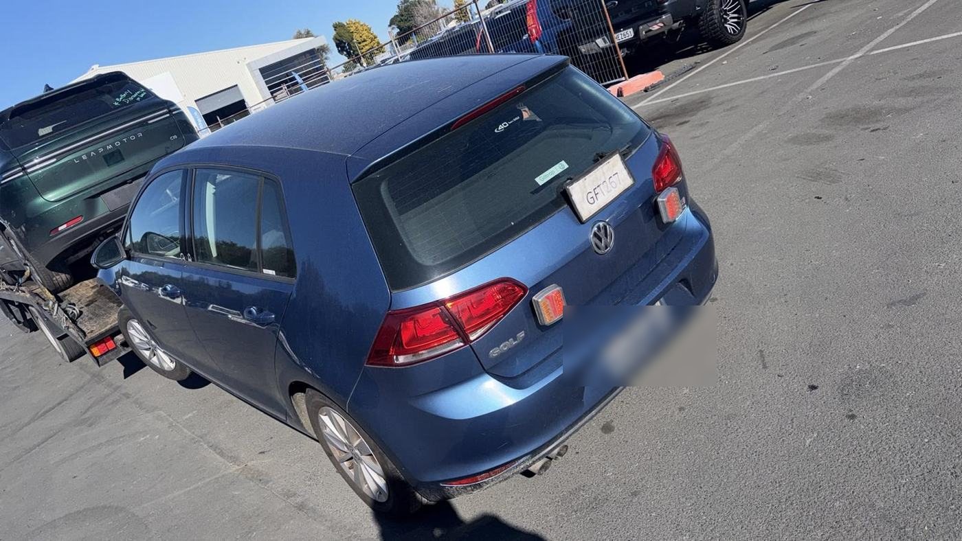 Blue VW Golf loaded for removal at the Auckland yard